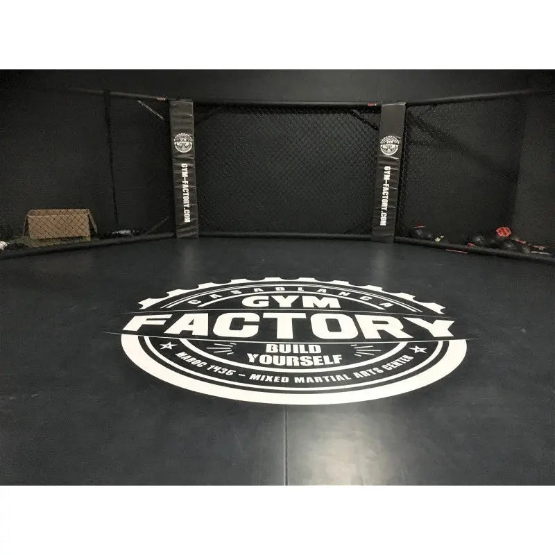 SportCom MMA-Käfig-Individualisierung: Detail des schwarzen Bodens mit rundem weißem Studio-Logo