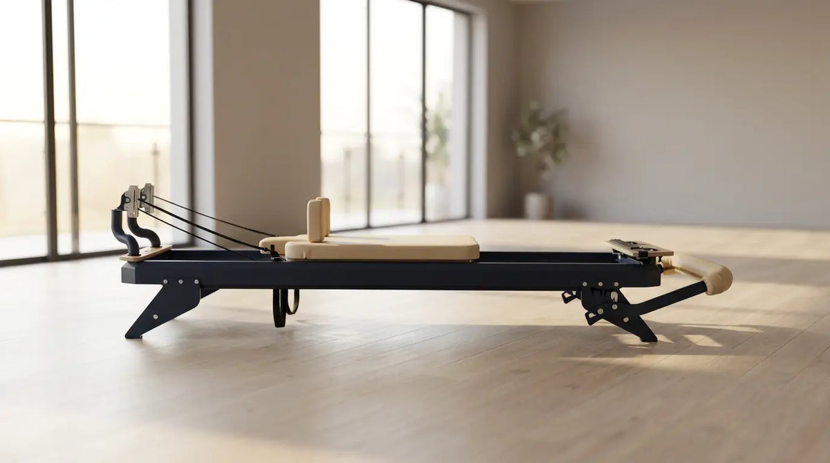 Premium Pilates reformer with a steel frame in a bright, clean studio