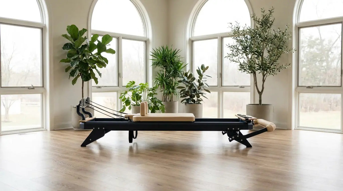 Premium Pilates reformer with a steel frame in a bright, modern studio