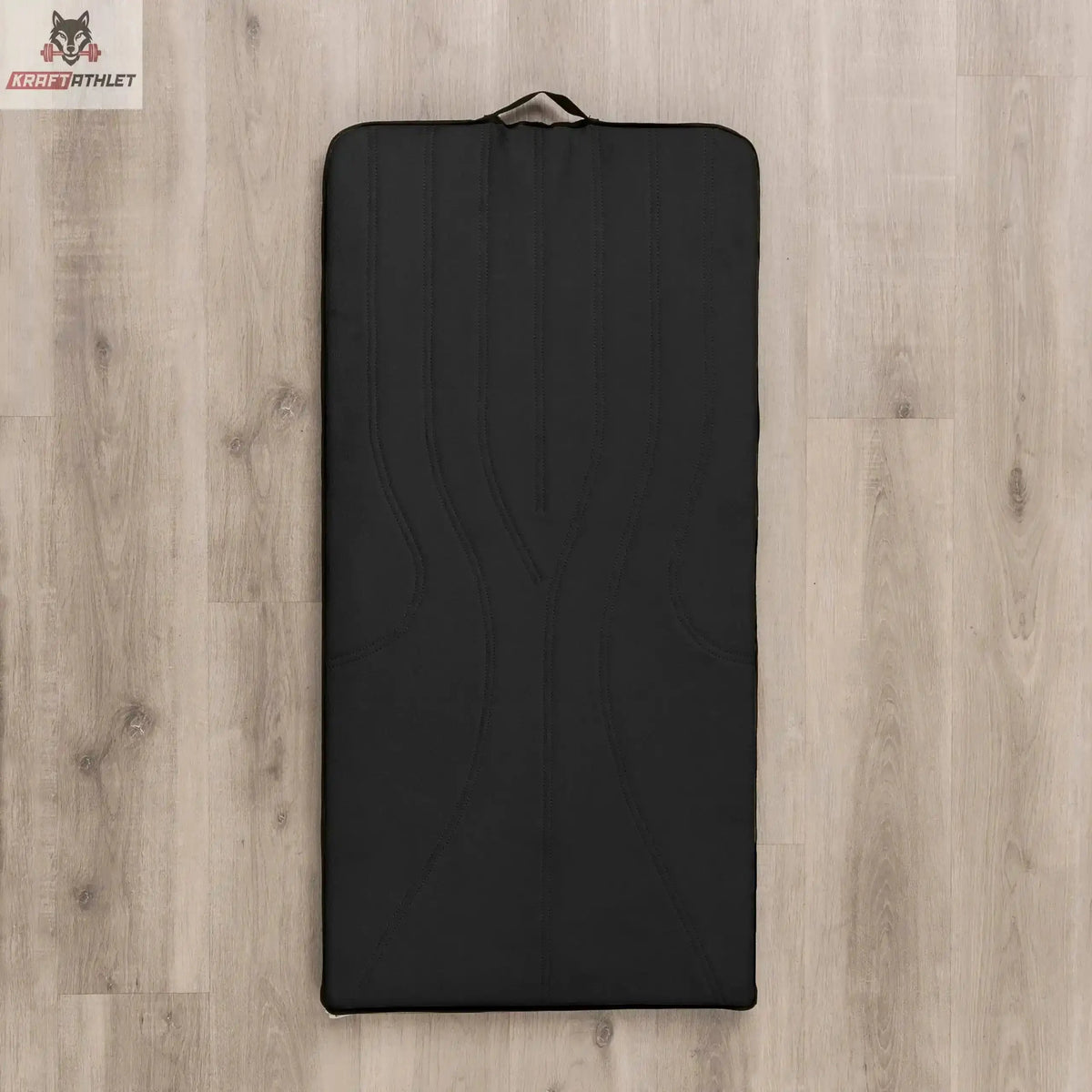 Hegren High Density Pilates-Matte in Schwarz, Draufsicht auf Holzboden mit Tragegriff am Kopfende