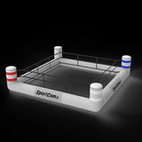 SportCom Aufblasbarer Boxring – Variante mit 2 Bannern, Schrägansicht von oben vor dunklem Hintergrund