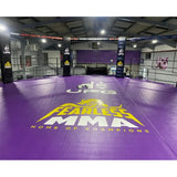 SportCom MMA-Käfig-Individualisierung: lila Bodenfläche mit gelbem Logo-Druck in einer großen Trainingshalle