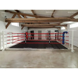 SportCom Trainingsboxring-Seil mit Hülle, rote und weiße Seile an einem Bodenring in heller Halle
