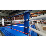 SportCom Wettkampf-Boxringseil mit Hülle, Blick über die Ringecke auf blaue Ringfläche in einer Halle